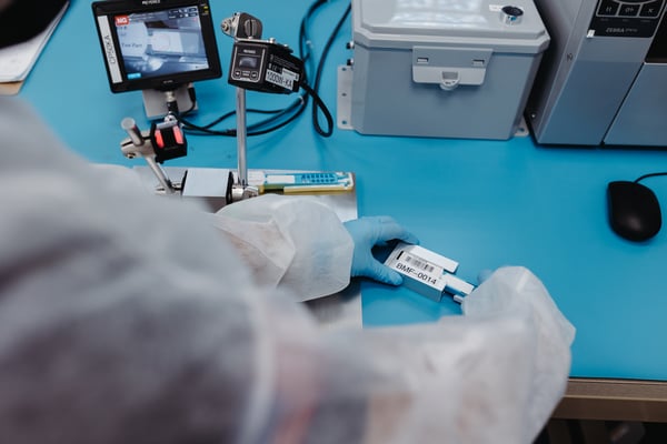 A close-up of an employee putting together a test kit