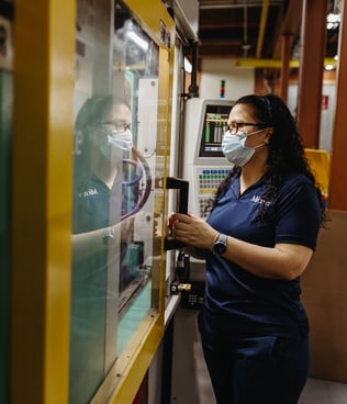 A woman looking into a machine