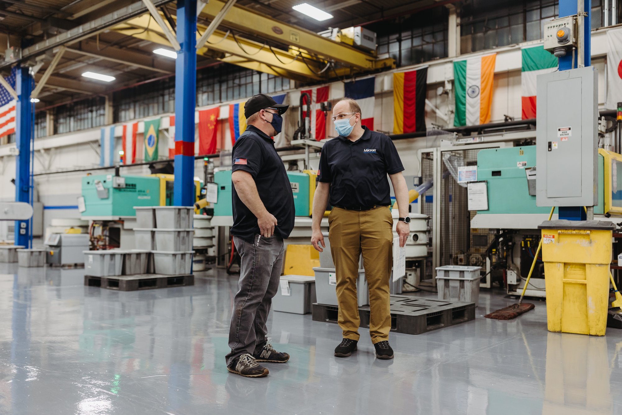 Two Micron employees on the manufacturing floor