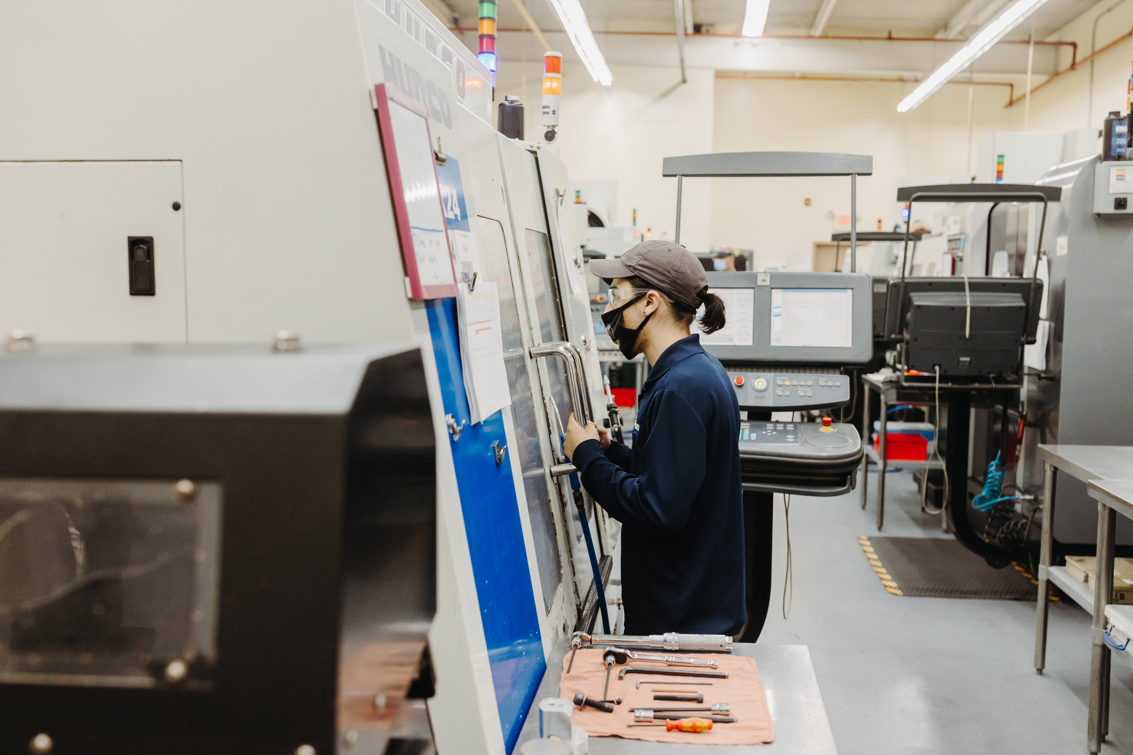 A man looks inside a CNC machine