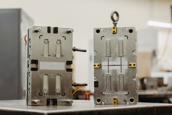 Two injection molds for consumable labware.