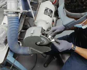A micron employee polishing a knee implant