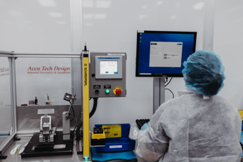 Woman looking at a screen in Micron Solutions' clean room