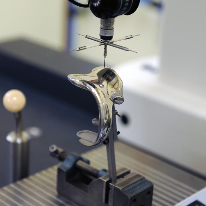 A CMM machine measures the dimensions of an orthopedic implant